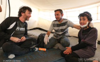 UNHCR High Profile Supporter, Neil Gaiman with Ayman, Syrian refugee volunteer nurse who provides medical assistance to the camp community.
