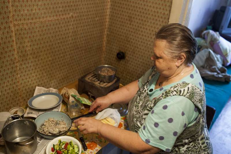 Tamara cooks in the dormitory where she recently started living. She is an internally displaced person in her own town, forced to move three times since her apartment was shelled.