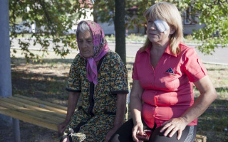 Liuba, 60, with her mother in the Kharkiv region. The two fled from their home town in eastern Ukraine with Liuba's husband. Liuba needed surgery for an eye injury.