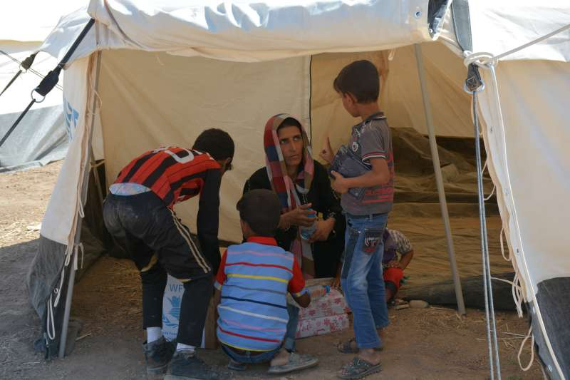 Sahla and three of her boys in their UNHCR tent at the Ministry of Agriculture site in Erbil, northern Iraq.
