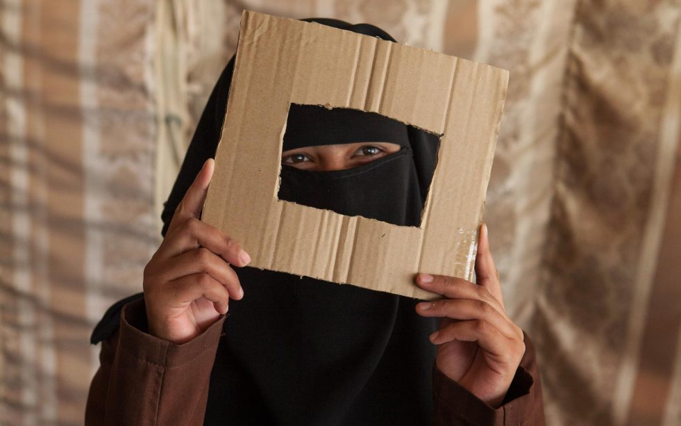 Before receiving a camera, Fatima learned to frame scenes with a piece of cardboard. 