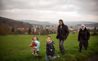 Young Abdu enjoys a walk with his family in the countryside near the German town Wächtersbach, where they were resettled. With cochlear implants and hearing aids, he can now hear almost perfectly.
