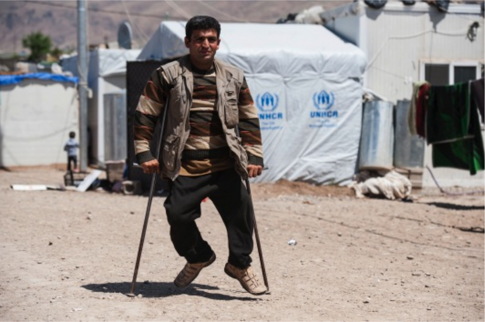 Gulber moves around Basirma Refugee Camp on homemade crutches