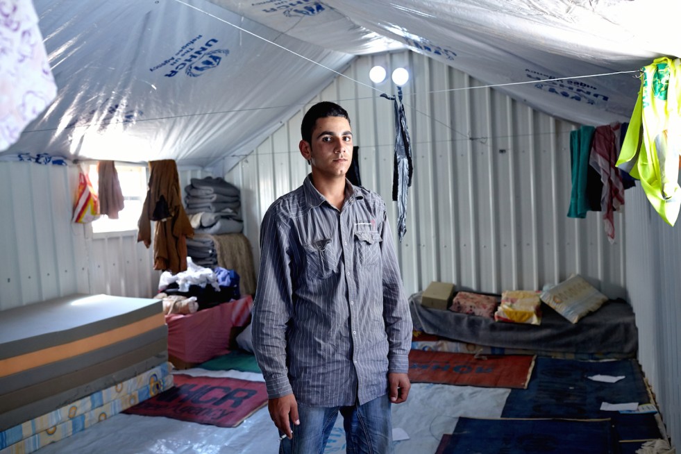 Amer, 20, inside his family’s shelter at Azraq camp. “With outside light we could gather more easily and talk with friends and family. Being able to socialize helps you feel better.”