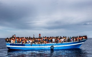 A boar carrying refugees and migrants, seen from a rescue vessel in June 2011.