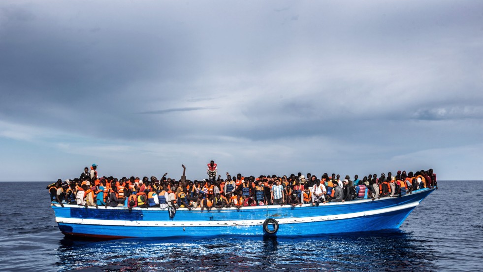 A boar carrying refugees and migrants, seen from a rescue vessel in June 2011.
