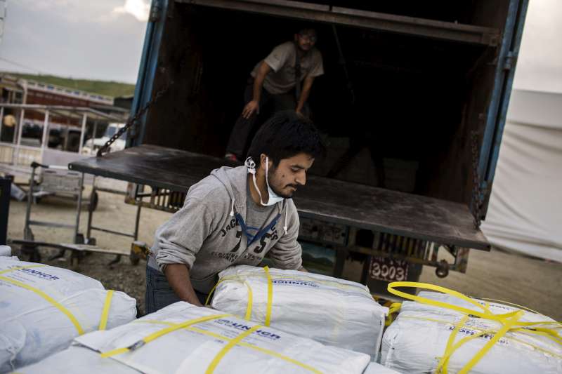 A worker loads UNHCR aid destined for delivery to thousands of people in quake-affected areas of Nepal.