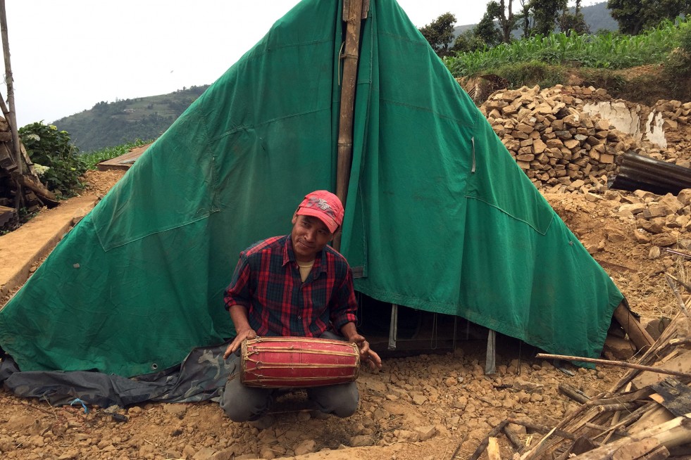 Jagat Thing, 42, lost his home but saved his family’s traditional drums. He entertains the village children with his playing, and his infectious laugh. 