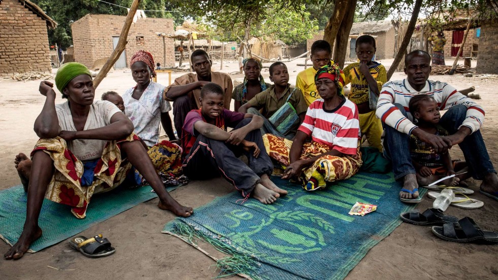 Jacob and his family rest by a tree in their new home in Chad. 