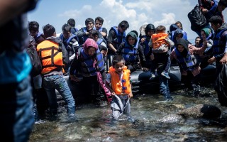 A group of Afghans wade ashore on Mytilini, on the Greek island of Lesvos.