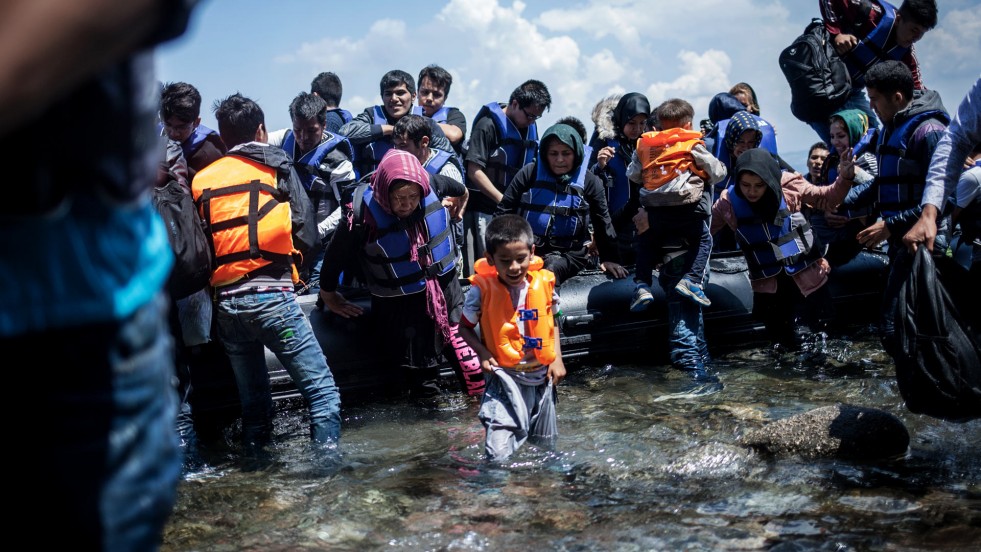 A group of Afghans wade ashore on Mytilini, on the Greek island of Lesvos.