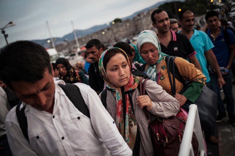 Refugees and migrants line up to board a night ferry from the Greek island of Kos to Athens.