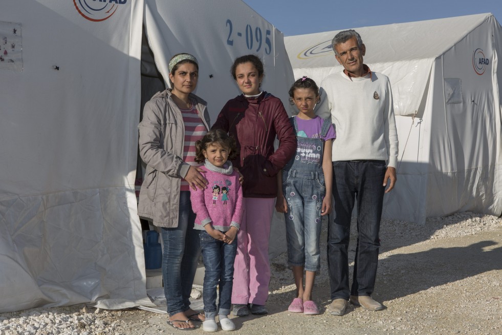  Ivra and her family photographed outside the tent where they live in Suruç camp. 