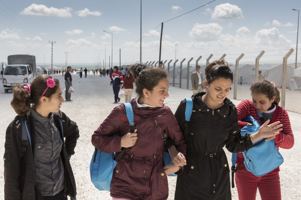 Ivra (second from the left) walks with friends on the way back to her family's tent after school in Suruç camp. 