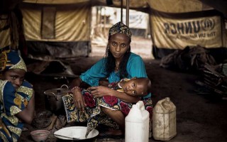 A CAR refugee with her family inside her tent in the site of Lolo, east of Cameroon.