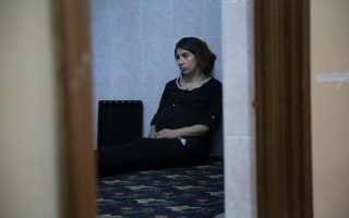 Shadiya, a Syrian refugee from Qamishli sits in the kitchen after a Ramadan iftar on June 19, 2015 in Dohuk, Iraq. For the past three years she has lived in an apartment with her sister's family in a block of low cost housing on the citys edge. Siblings, nieces and nephews filled the living room sofas as Iftar nears, but the familys older generation is notably absent. Her parents are still in Syria. They were too old to make the long journey from northern Syria into Turkey and back down to Iraq. Iraqs Kurdistan Region is hosting at least 300,000 Iraqis displaced from other parts of the country and more than 240,000 Syrians fleeing violence. For both Syrian refugees and displaced Iraqis, this is not the first year theyve celebrated the holy month of Ramadan away from home. Once a month full of big family dinners and late nights visiting with neighbours, for those uprooted by violence, Ramadan has become a reminder of homes lost and loved ones far away.