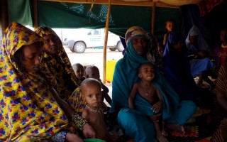 Aminata, late-20s, and her family and other new arrivals sit inside one of the tents at Mbera Camp, some 50 km inside Mauritania.