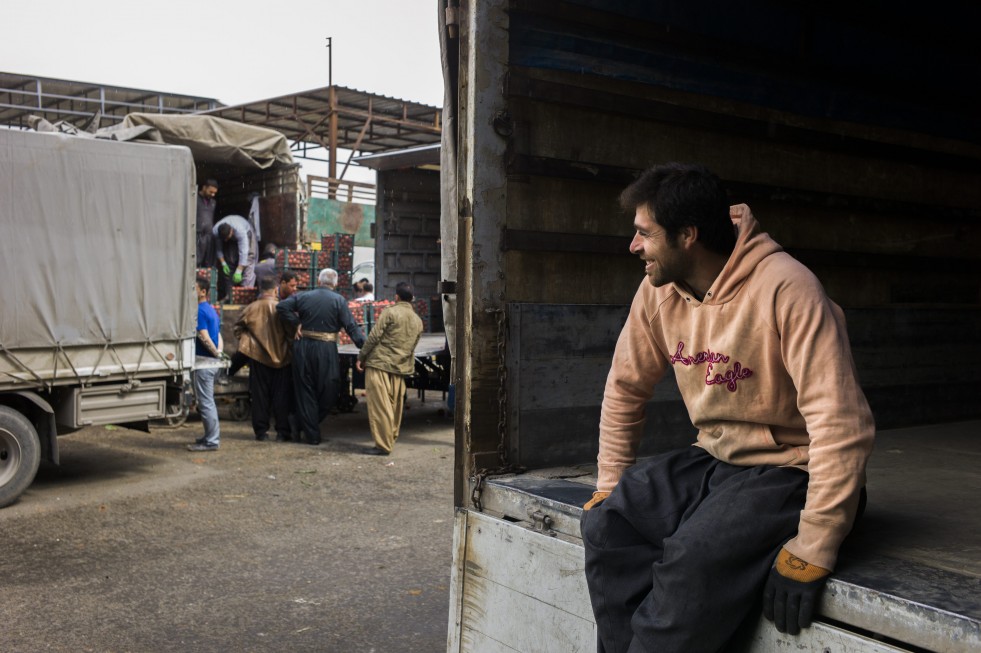 Ronak waits for the truck he is working on to pull up to the tomato seller. "It's so much better than in Syria," he says. "Here we have opportunities." 