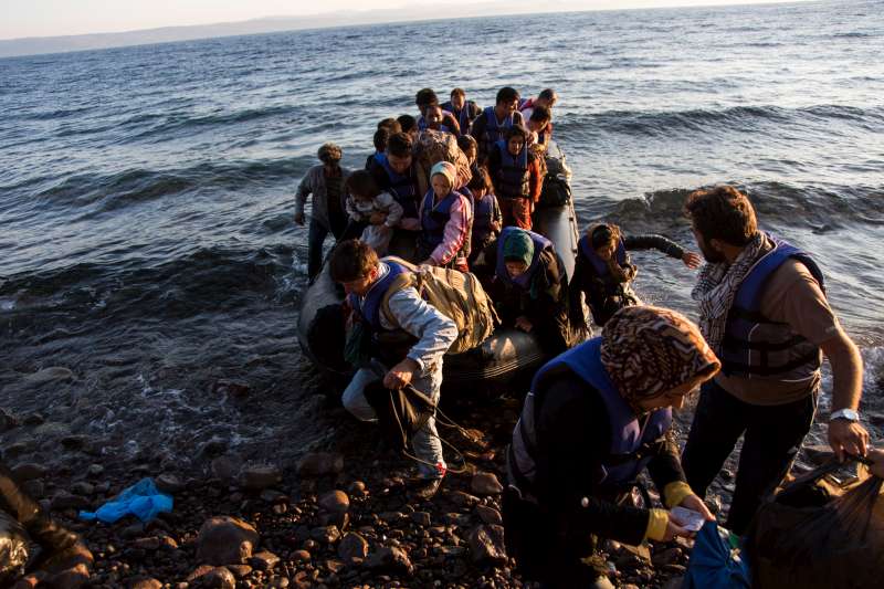 A group of Afghans recently arrive on the island of Lesbos after travelling in an inflatable raft from Turkey to Greece. More than 300,000 refugees and migrants have used the dangerous sea route across the Mediterranean so far this year.