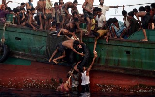 Young Rohingya leapt into the sea to retrieve supplies dropped by a helicopter on 14 May.