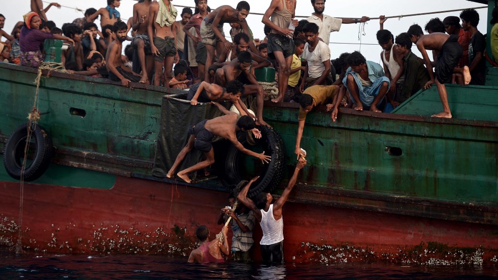 Young Rohingya leapt into the sea to retrieve supplies dropped by a helicopter on 14 May. 