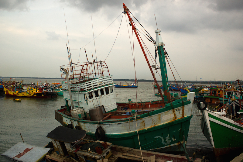 A smugglers' boat that was abandoned by its crew in May and drifted to Indonesia is docked in Lhokseumawe. Its passengers disembarked to temporary shelters. 