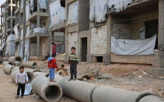 Syrian children play in the streets of Aleppo, home to well over a million internally displaced people, in November 2014.