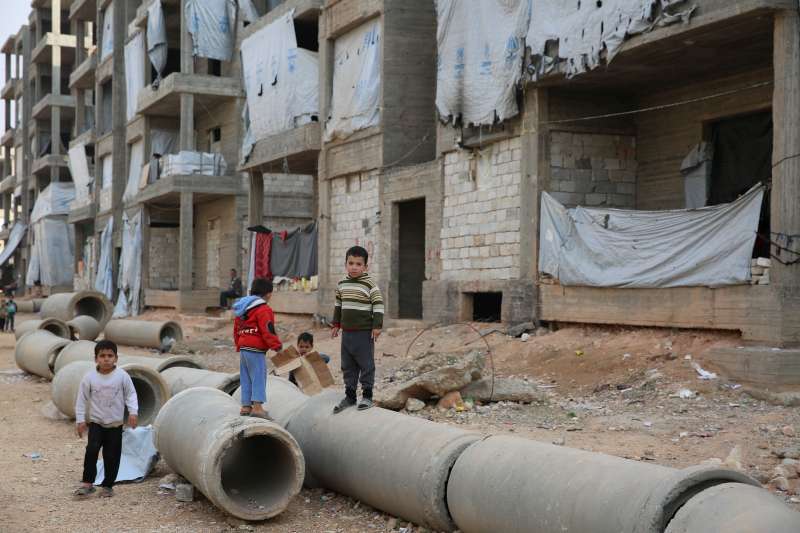 Syrian children play in the streets of Aleppo, home to well over a million internally displaced people, in November 2014.