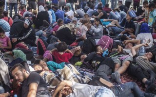 People rest at the Tovarnik train station in Croatia, while waiting for transportation to a refugee camp near Zagreb.