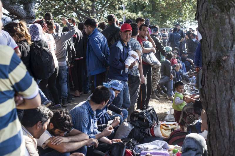 Tired refugees fleeing war in Syria and elsewhere at the Croatian government transit centre in Opatovac near border with Serbia.