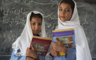 Haseena, nine years old, left, and Nadia, twelve years old. The sisters are the second generation of Afghan refugee girls to attend Asifi’s school. Their mother, Salma, was among the first girl students two decades ago.