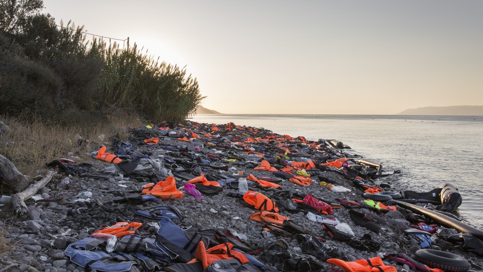 Discarded life jackets and inflatable boats litter a beach on Lesvos.