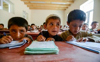 Haqmal (centre), a six year-old returnee from Pakistan loves his new school, the Ansarul-Momineen School in Pajhman, Kabul District Afghanistan.