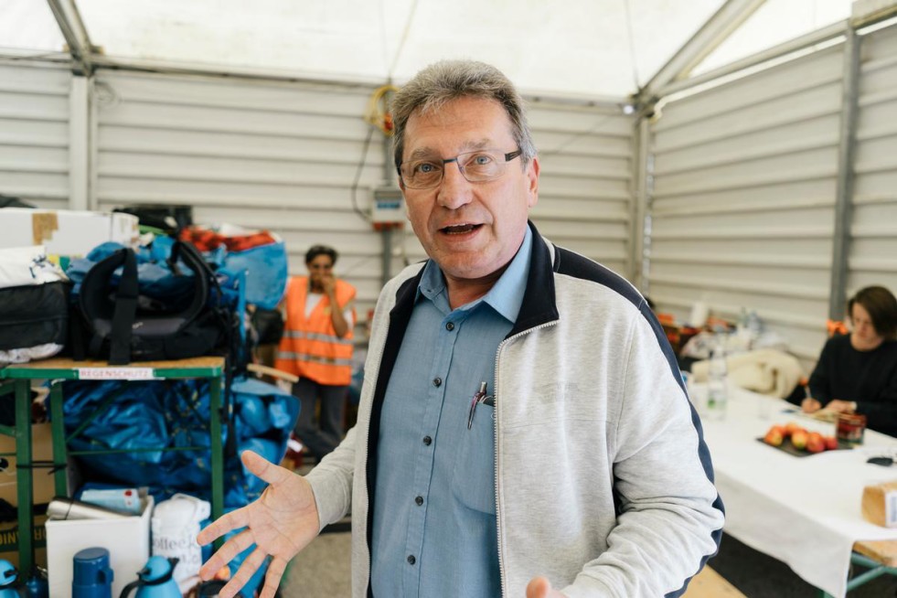 Gerhard Zapfl has been the Mayor of Nickelsdorf for 19 years. This is first time he has had to help manage a big tent where donated supplies are organised. 