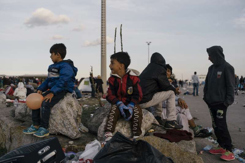 Two young refugees wait with their parents to go to emergency accommodation in Nickelsdorf, Austria, earlier this month. Austria is facing an unprecedented arrival of refugees, mainly from Syria, Iraq and Afghanistan.