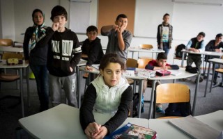 Syrian 12-year old Leen (front) concentrates on the board during a language class