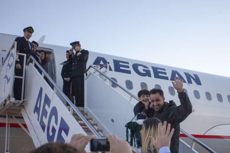 Asylum-seekers board a flight from Athens to Luxembourg. 