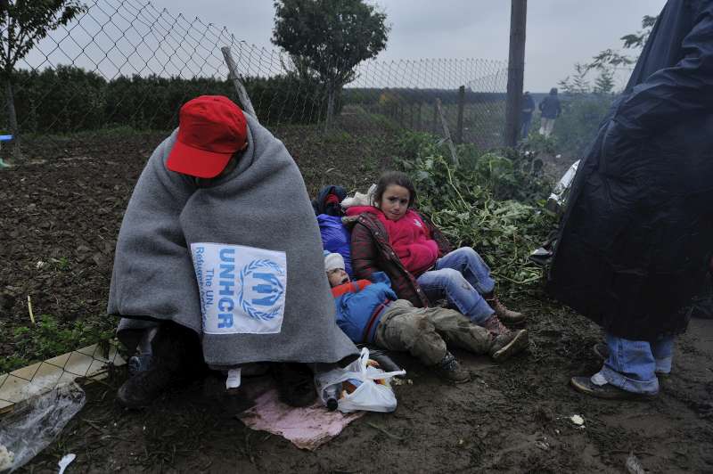 A refugee huddles up against the cold on the border between Serbia and Croatia.