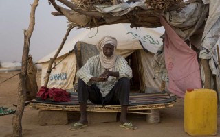 Malian refugee Alassane Maïga sits on a makeshift bed at Abala refugee camp in Niger.