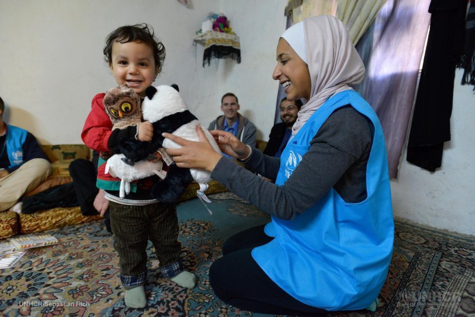 Baby Mawther eighteen months recieving toys as gifts from IKEA during a home vist by UNHCR syaff and a team from IKEA norway . This is the Sulimain family. Amman Jordan