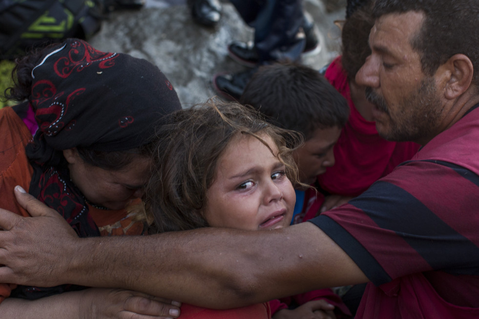A family of Syrian refugees cry and comfort each other after a rough and scary crossing from Turkey.