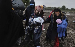 Syrian refugee Mohamed, his wife Fatima and their two babies wait in Serbia to cross into Croatia.