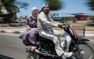 Ahmad and his wife, Nazmiya , leave a UNHCR volunteer meeting at the UNHCR offices in Tripoli, Lebanon.