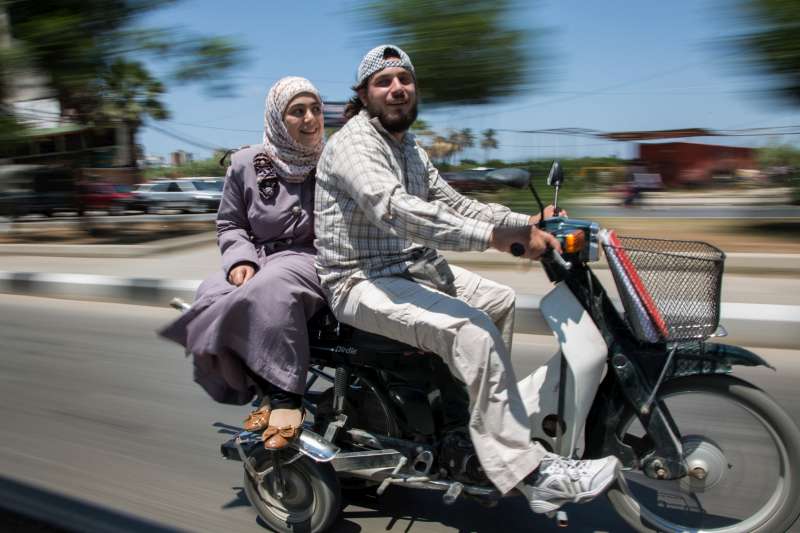 Ahmad and his wife, Nazmiya , leave a UNHCR volunteer meeting at the UNHCR offices in Tripoli, Lebanon.