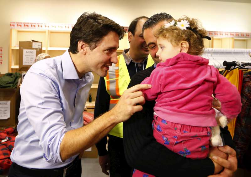 Des réfugiés syriens sont accueillis par le Premier ministre du Canada, Justin Trudeau (à gauche sur la photo), à leur arrivée à l'aéroport international Pearson de Toronto.