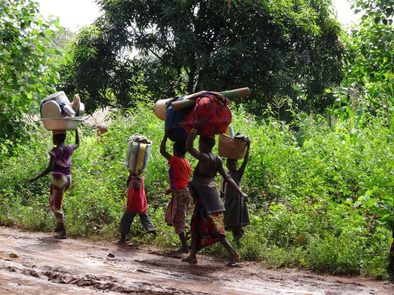 A group of people carrying their belongings flee attacks in Central African Republic.