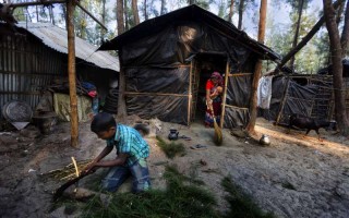 A family displaced from Kutubdia Island by rising sea levels makes a home on higher ground at Cox's Bazar, Bangladesh.