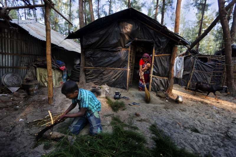 A family displaced from Kutubdia Island by rising sea levels makes a home on higher ground at Cox's Bazar, Bangladesh.