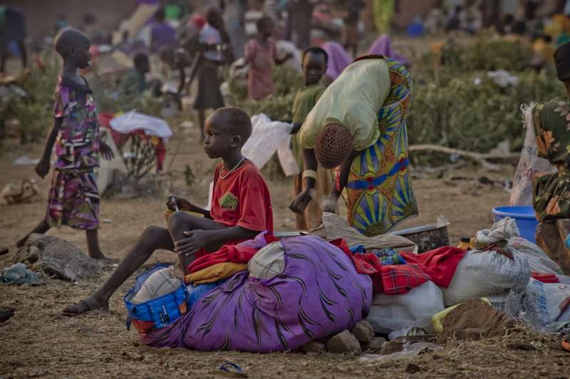 A young South Sudanese boy sits on a bundle of clothes at Dzaipi Reception Centre in northern Uganda.