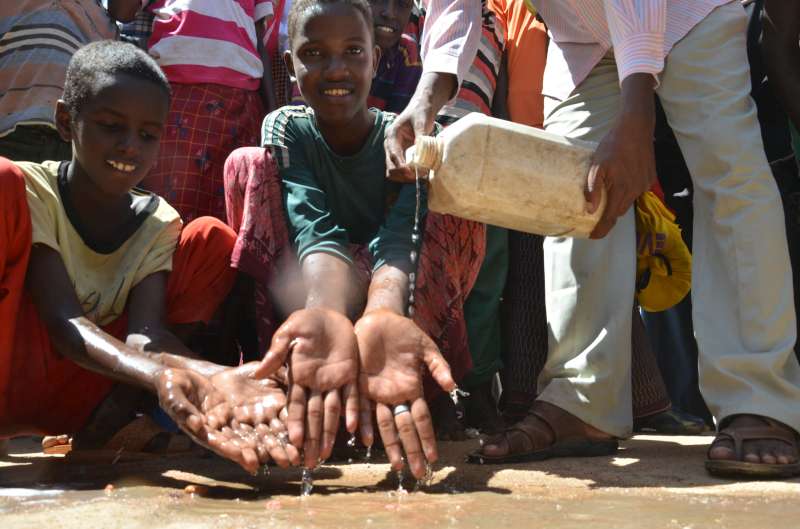 Abdulsalam, 12 and Faisal, 15 from Somalia washing their hands with soap as they take part in a hand washing campaign in Dadaab as part of the response to the current Cholera outbreak.